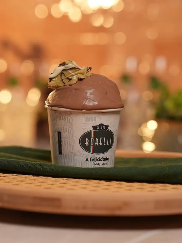 Copo de gelato de chocolate com luzes quentes desfocadas ao fundo